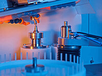Laboratory testing equipment with multiple probes and cylindrical components under inspection