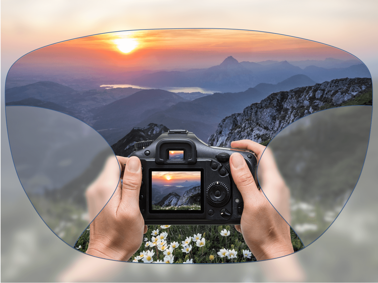 View through a pair of glasses showing hands holding a camera, capturing a mountain landscape with a sunset