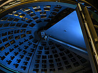 Interior view of semiconductor processing equipment with a large circular rotating wafer holder.