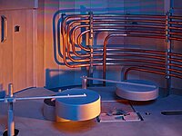 Industrial machine interior with metal pipes, circular components, and control elements