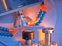 Laboratory machine with multiple probes and coolant nozzles inspecting cylindrical samples