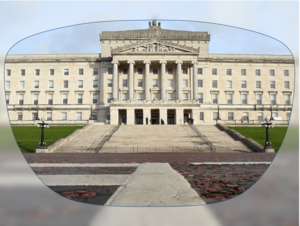 View through a pair of glasses showing a large neoclassical government building with columns and wide stone steps.