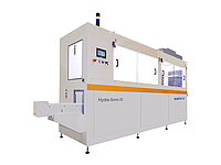 Side view of a large automated semiconductor processing system with control panel and enclosed chambers.