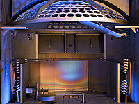 Interior of semiconductor processing equipment with circular wafer holder and metallic chamber components.