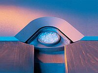 Close-up of a machine chamber with illuminated round component inside