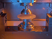 Close-up of a Satisloh GI grinding disc tool used in precision optics manufacturing.