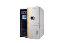 Industrial vacuum coating machine with touchscreen control panel, used for optical lens production.