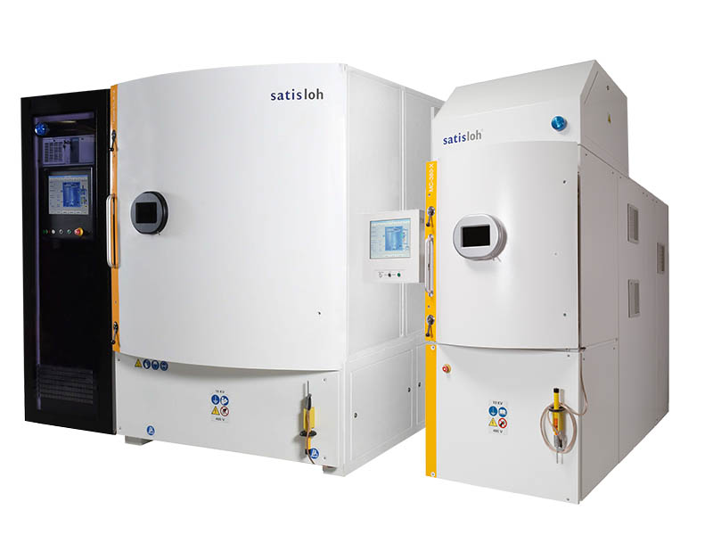 Large industrial coating machines with control panels, used in manufacturing processes.