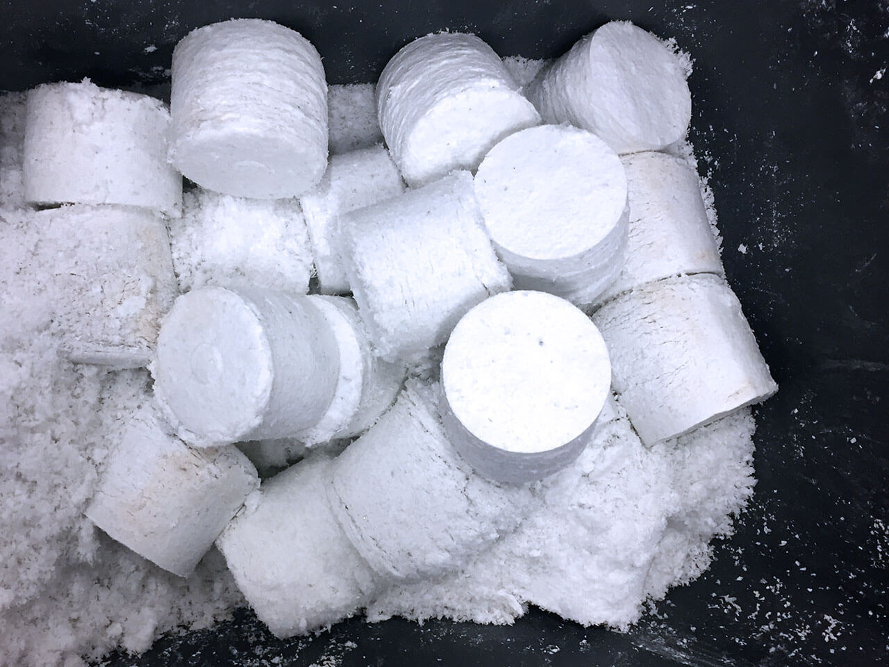 Close-up of multiple cylindrical white pellets stacked together.